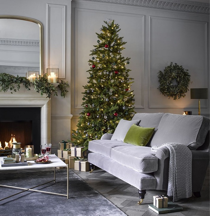The sofa is a focal point for living room Christmas decor. Image via Pinterest.