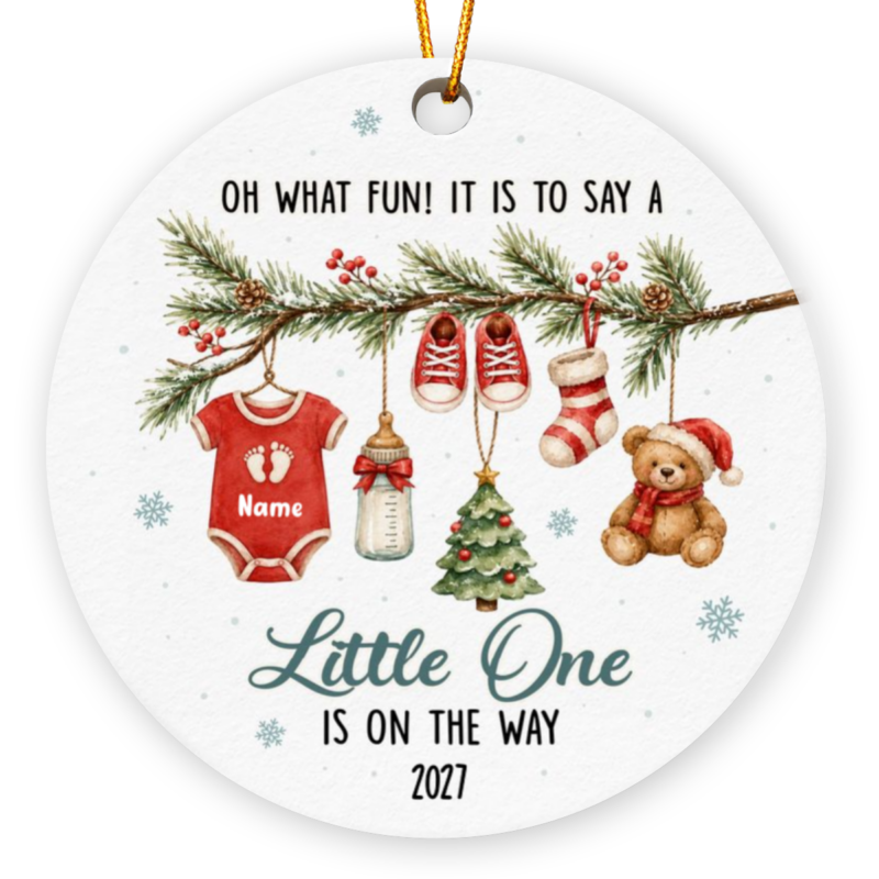 Baby announcement Christmas ornament in red gender-neutral theme with a pine branch holding a red baby onesie, bottle, tiny shoes, stocking, Christmas tree, and teddy bear, personalized with baby name "Thomas" and text "Little One Is On the Way 2026"
