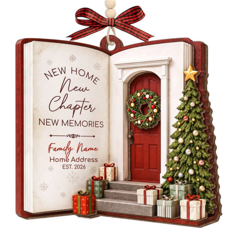 Personalized new home ornament shaped like an open storybook, custom with "The Wilson Family, 1732 Cove Way, Underhill, Est. 2026" beside an illustrated front door with a wreath, Christmas tree, and wrapped gifts on the steps