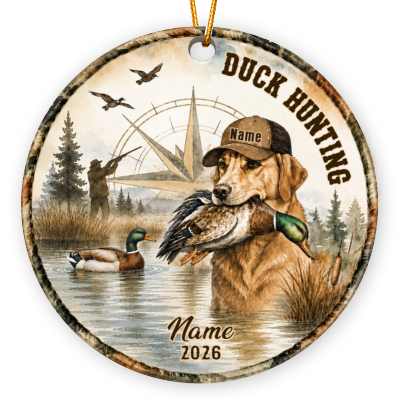 Duck hunting ornament featuring a golden retriever wearing a cap labeled "Charlie" holding a mallard duck, with a hunter, compass, and marsh landscape, personalized with "Robert 2026"